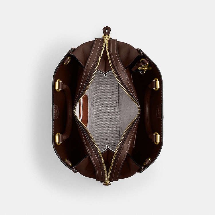COACH ROGUE 31 in MAPLE (Category: Luxury Bags & Wallets) located in Las Pinas. Submitted by shopwithmira13 (Listing ID 1464194485, Image 2). Description: - Authentic Coach Bag - Elegant Gold Hardware - Versatile Top Handles and Detachable Shoulder Strap - Secure Lock and Key Detail - Spacious Interior for All Your Essentials - Ideal for Everyday Errands or Special Occasions.