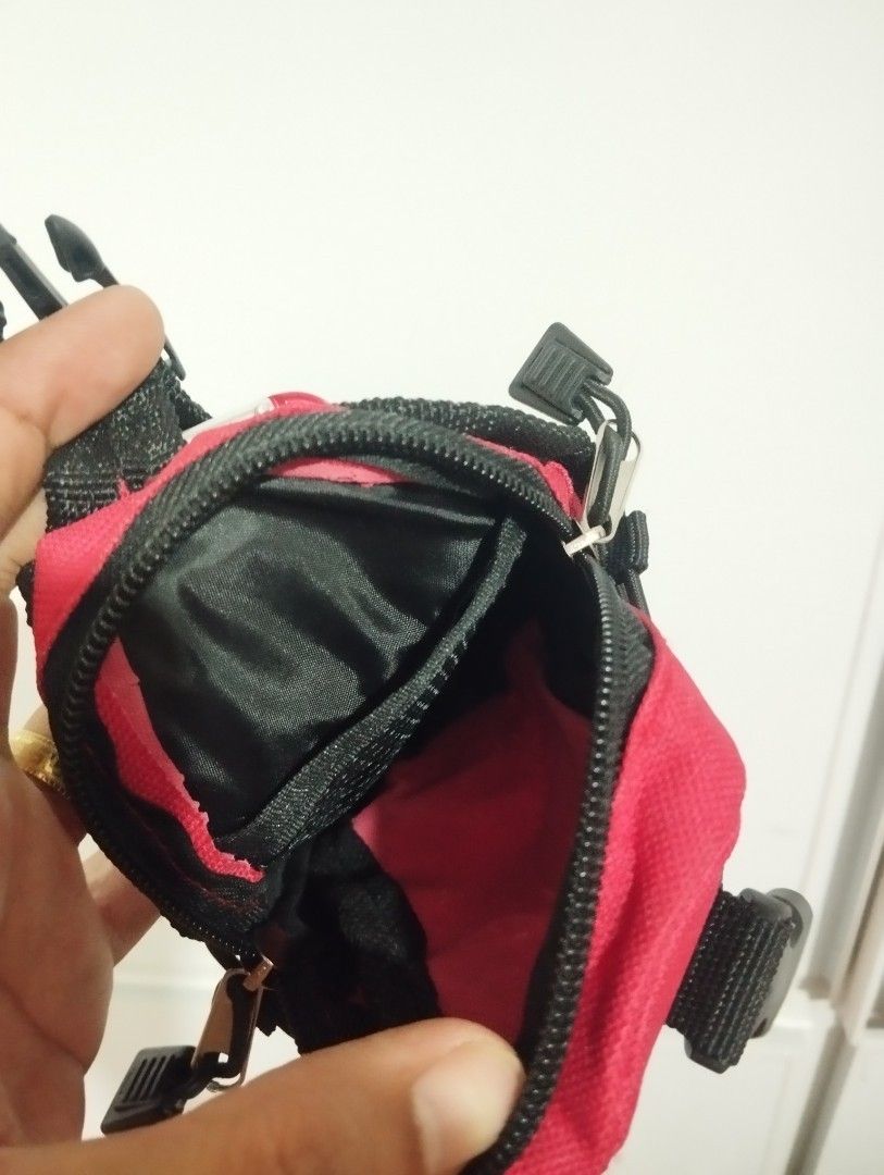 Coleman Mini Backpack Keychain Pouch Red (Category: Purses & Pouches) located in Candon. Submitted by bernabepradoiii (Listing ID 1464282804, Image 3). Description: - Compact red Coleman pouch - Features a carabiner clip for easy attachment - Buckle strap for secure closure - Mesh front pocket with bungee cord detail - Zipper closure for main compartment - Perfect for organizing keys, coins, or other small essentials - Great for camping trips or 