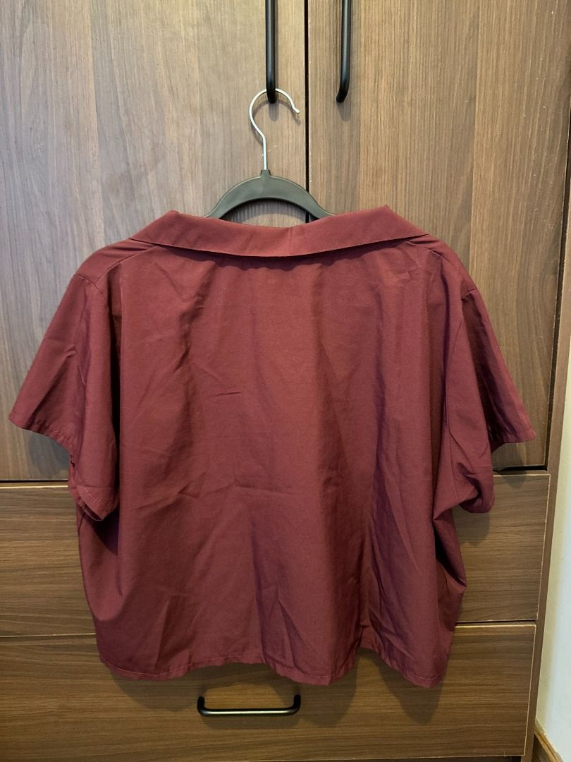 Collared V-Neck Top | Maroon | Fits up to XL (Category: Shirts) located in Makati City. Submitted by autumn.latte (Listing ID 1464250010, Image 2). Description: ♡ Relaxed fit—perfect for running errands - Color: Maroon - Collared V-neck design - Short sleeves - Relaxed fit - RFS: Too many maroon/burgundy tops 🌷 Pre-loved. Please see photos for actual condition. 🛍️ MOP: BPI / GCash / MariBank only 🛵 Shipping shouldered by buyer via Grab / Lalam