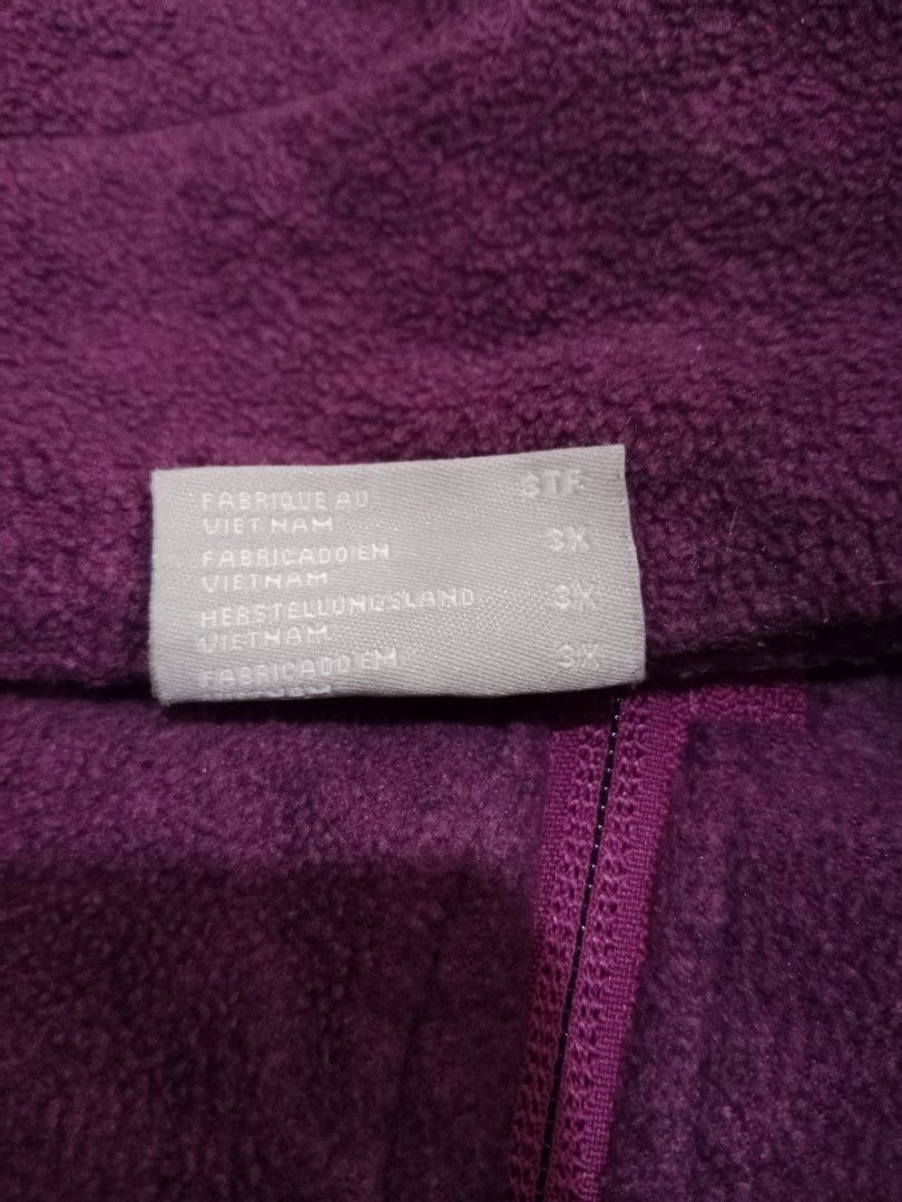 Columbia (Category: Coats, Jackets and Outerwear) located in Naga. Submitted by thrift.vincent (Listing ID 1464166483, Image 3). Description: Columbia full zip fleece jacket in purple. 100% polyester fleece, raglan sleeves, mock neck collar. Embroidered Columbia logo patch on left chest. Two zippered hand pockets. Tonal purple zipper with elastic drawcord and plastic toggle at hem. No visible wear, no defects.
