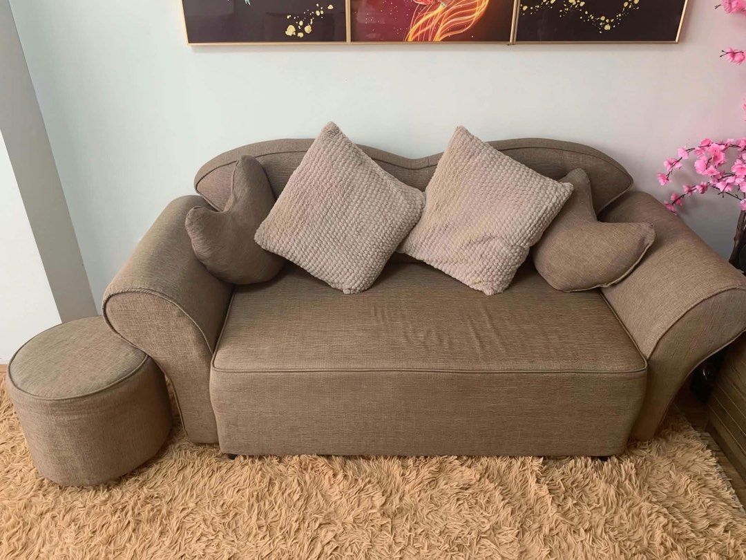 Comfortable 2-Seater Sofa with Ottoman (Category: Sofas) located in Manila. Submitted by d_carthub (Listing ID 1464165606, Image 1). Description: - Cozy 2-seater sofa with matching ottoman - Upholstered in neutral beige fabric - Comes with 2 square throw pillows and 1 heart-shaped pillow - Ideal for small living spaces or as an accent piece - Ottoman can be used for footrest or extra seating .
