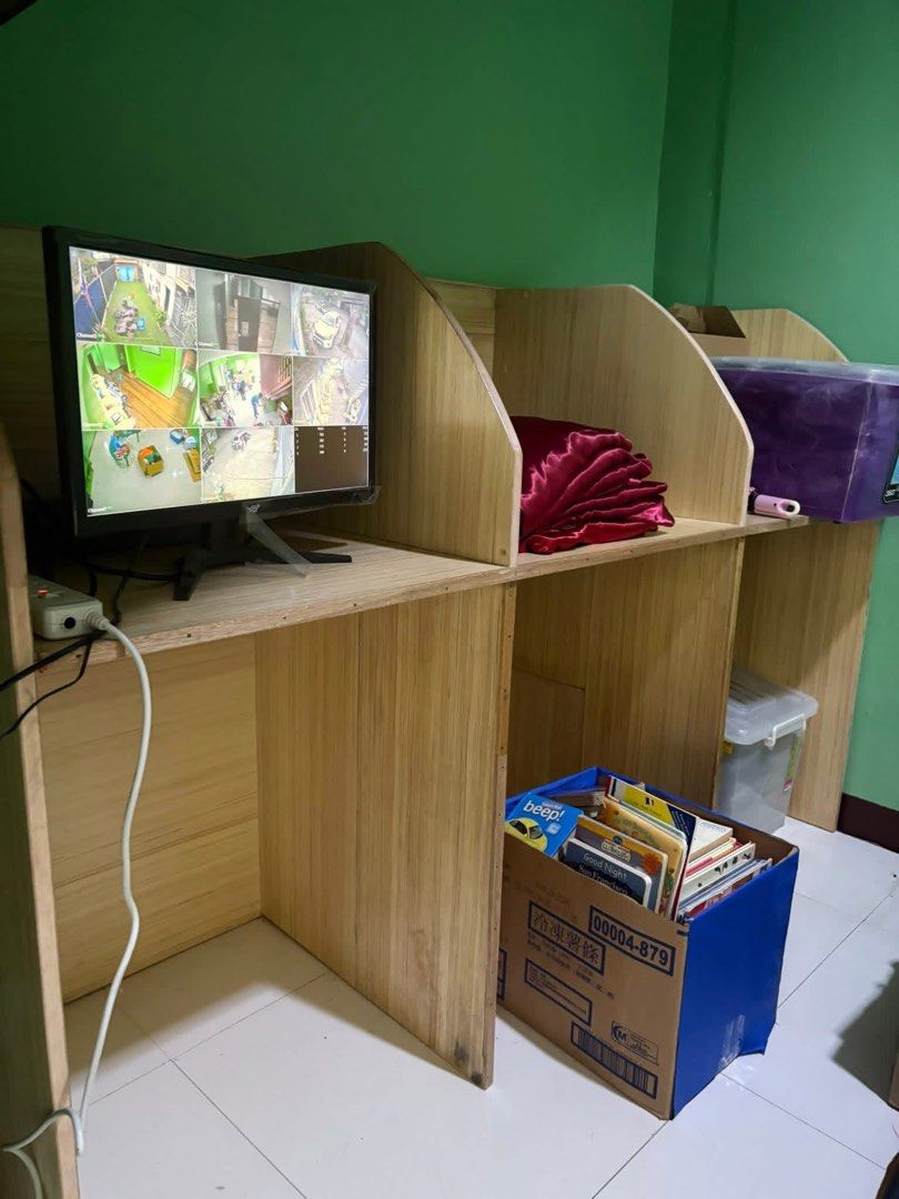 Computer table with division (Category: Office Furniture & Fixtures) located in Paranaque City. Submitted by lilovpb (Listing ID 1464180395, Image 1). Description: - CCTV monitor displaying multiple camera feeds - Mounted on a wooden desk with cubicle dividers - Includes power cables and a surge protector - Ideal for security monitoring - Sold as is.