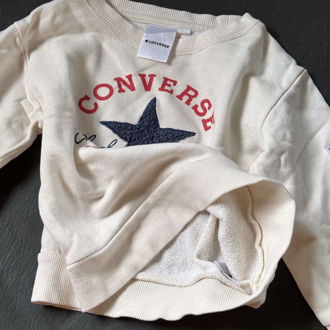 Converse Chuck Taylor Sweatshirt (Category: Babies & Kids Fashion) located in Mati. Submitted by sharieeng (Listing ID 1464148826, Image 2). Description: - Cream colored Converse sweatshirt - Features classic Chuck Taylor All Star logo on front - Small Converse patch on sleeve - Soft and cozy interior - Perfect for casual wear.