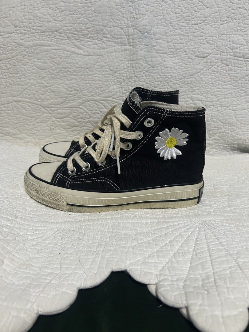 Converse High-Top Sneakers with Daisy Embroidery (Category: Sneakers) located in Malaybalay. Submitted by thrifturessential (Listing ID 1464279749, Image 2). Description: - Black Converse high-tops - Cute daisy embroidery on the side - Cream colored laces - Soles show some signs of wear - Size: US Women's 5 - Perfect for casual wear.