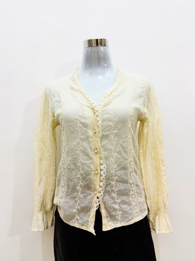 Cream Lace Trimmed Embroidered Blouse (Category: Blouses) located in Manila. Submitted by e.louise (Listing ID 1464334916, Image 2). Description: - Elegant cream-colored blouse - Features delicate embroidery and lace trim - Button-up front with pearl-like buttons - Feminine ruffled cuffs and neckline - Lightweight fabric, perfect for layering - Pairs beautifully with skirts or trousers.