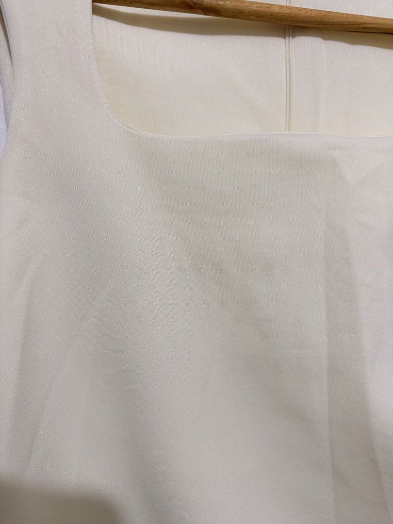 Cream Square Neck Sleeveless Ruched Top (Category: Sleeveless) located in Caloocan City. Submitted by ashpreloves (Listing ID 1464192504, Image 2). Description: - Brand new - Square neckline - Ruched detailing on the side - Zipper closure at the back - Stretchy and comfortable material - Perfect with high-waisted bottoms.