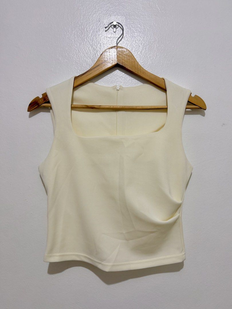 Cream Square Neck Sleeveless Ruched Top (Category: Sleeveless) located in Caloocan City. Submitted by ashpreloves (Listing ID 1464192504, Image 1). Description: - Brand new - Square neckline - Ruched detailing on the side - Zipper closure at the back - Stretchy and comfortable material - Perfect with high-waisted bottoms.