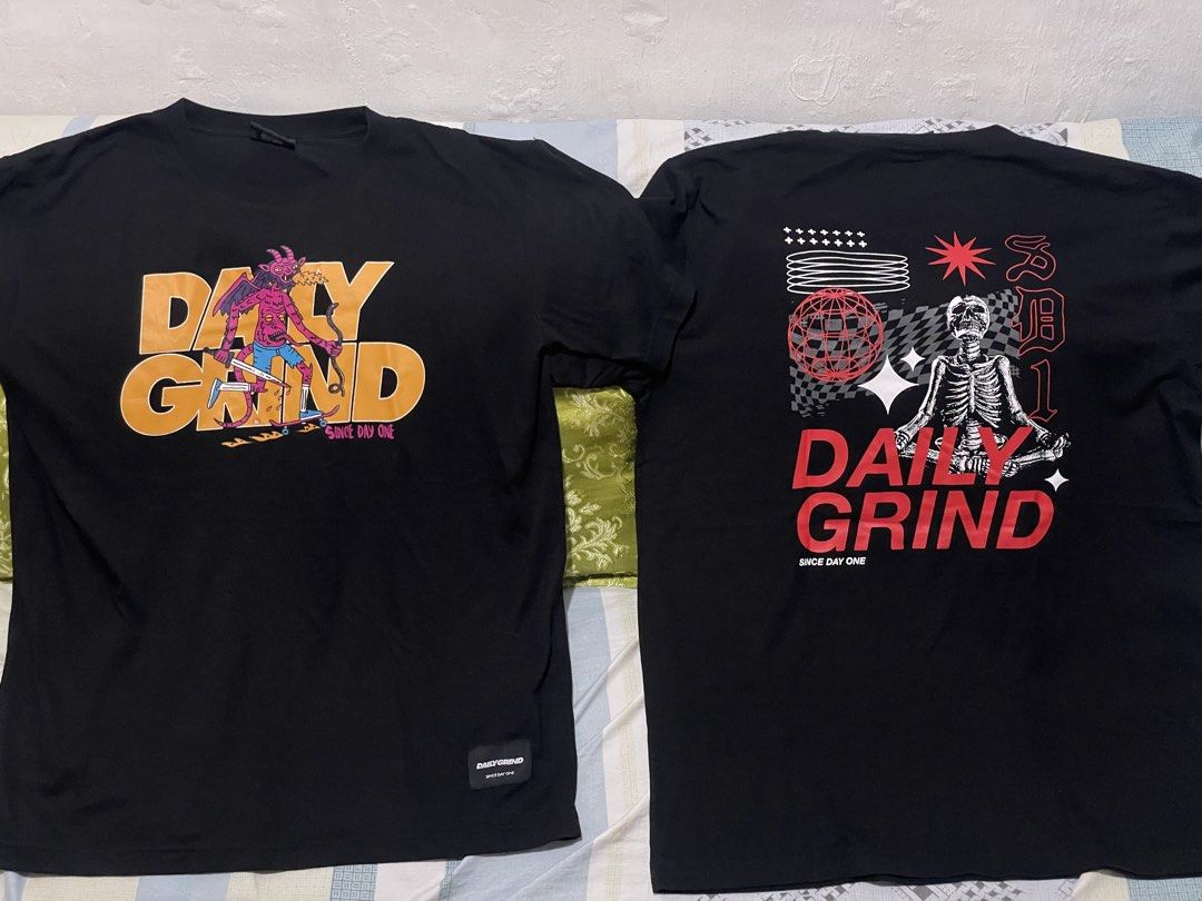 Daily Grind T-shirt Bundle - Black (Category: Tshirts & Polo Shirts ) located in Makati City. Submitted by christian_g (Listing ID 1464250274, Image 2). Description: - Two black Daily Grind t-shirts - Size: Large - Shirt 1: Front graphic print with a devil character - Shirt 2: Small chest graphic and large back graphic with a skeleton - Ideal for everyday wear.