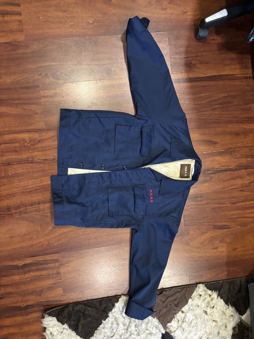 Dark Blue Work Jacket with Red Embroidery (Category: Coats, Jackets and Outerwear) located in Quezon City. Submitted by closetskey (Listing ID 1464247734, Image 1). Description: - Dark blue work jacket - Button closure - Two chest pockets - Red embroidery detail on left chest - Light tan inner lining - Durable material for everyday wear.