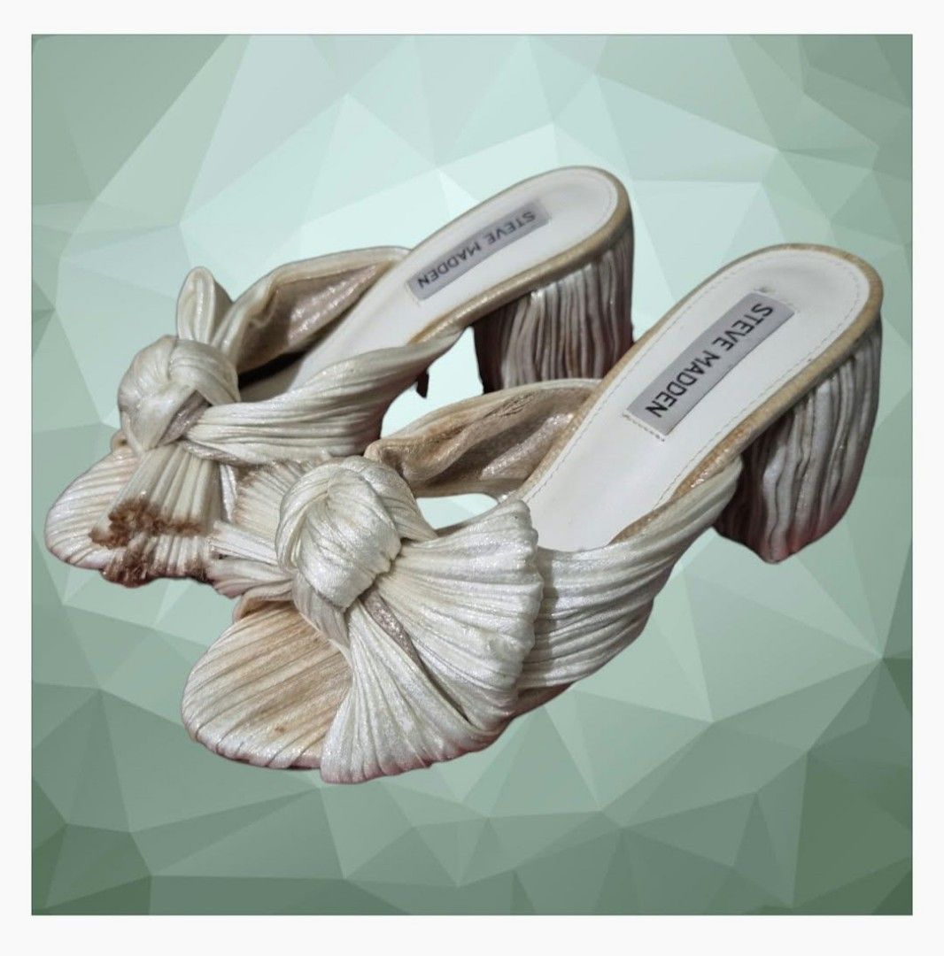 Steve Madden Deacon Knot Block Heeled Sandal (Category: Sandals) located in Paranaque City. Submitted by calm_youngstore7 (Listing ID 1464322466, Image 1). Description: Deacon Knot Slide Sandal In Metallic Ivory with ombre chrome edges Puckered, crinkled fabric brings modern texture to a party-ready sandal shaped with a wrapped column heel and an artfully knotted bow over the toe. Textile upper/synthetic lining and sole Imported Steve Madden Deac