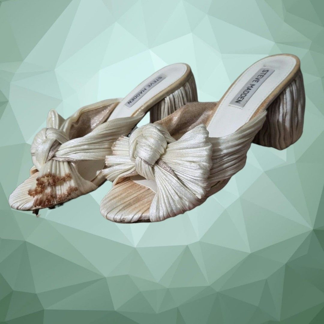 Steve Madden Deacon Knot Block Heeled Sandal (Category: Sandals) located in Paranaque City. Submitted by calm_youngstore7 (Listing ID 1464322466, Image 2). Description: Deacon Knot Slide Sandal In Metallic Ivory with ombre chrome edges Puckered, crinkled fabric brings modern texture to a party-ready sandal shaped with a wrapped column heel and an artfully knotted bow over the toe. Textile upper/synthetic lining and sole Imported Steve Madden Deac