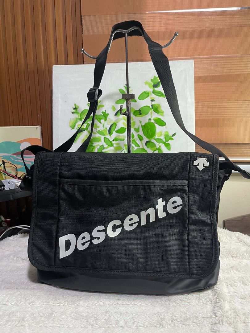 Descente Black Messenger Bag (Category: Sling Bags) located in Naawan. Submitted by twilly.apparel2 (Listing ID 1464345262, Image 1). Description: - Black Descente messenger bag - Durable material for long-lasting use - Spacious main compartment for essentials - Convenient front pocket for quick access - Adjustable strap for a comfortable, customized fit - Features the iconic Descente Athletic logo on the strap - Ideal for everyday errands or spo
