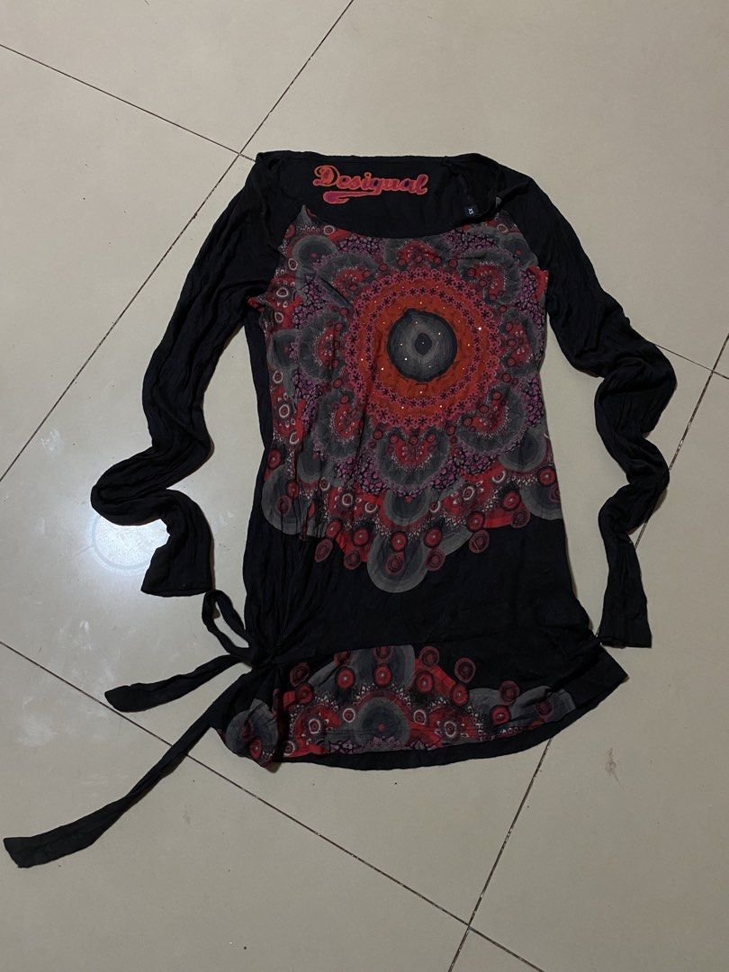 Desigual Black Long Sleeve Top with Mandala Print (Category: Longsleeves) located in Binalbagan. Submitted by southsidethrift22 (Listing ID 1464183154, Image 1). Description: - Desigual black long-sleeved top - Size: XS - Eye-catching colorful mandala-inspired print on the front - Unique tie detail on the side hem - Fitted sleeves - Made from soft, comfortable fabric.
