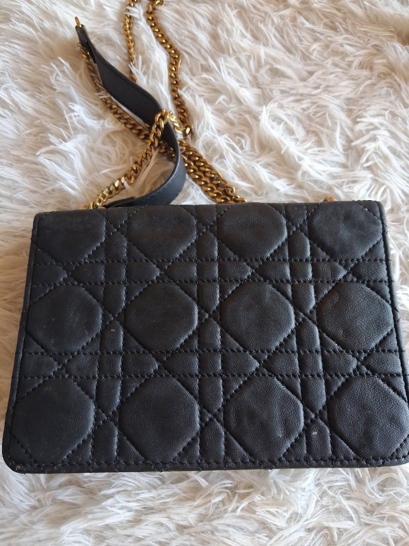 Dior Quilted Black Leather Chain Shoulder Bag (Category: Cross-body Bags) located in Agoncillo. Submitted by vinsoy07 (Listing ID 1464140964, Image 3). Description: - Black quilted leather Dior bag - Gold chain strap and hardware - Iconic Dior clasp - Approximately 7 inches wide - Ideal for evenings or adding luxury to daily wear - Spacious interior for essentials.