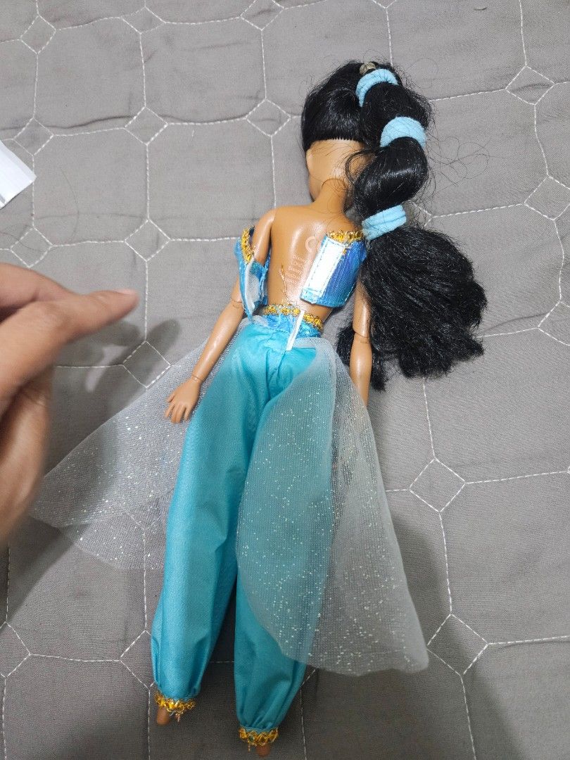 Disney Princess Jasmine Doll (Category: Plushies & Soft Toys) located in Tarlac. Submitted by dhiyanatividad (Listing ID 1464254700, Image 2). Description: - Authentic Disney's Aladdin Jasmine doll. - Iconic blue outfit with gold trim. - Long, black hair styled in a ponytail. - Outfit includes sparkly pants and top. - Minor marks present on the pants. - Ideal for any Disney fan or collector..