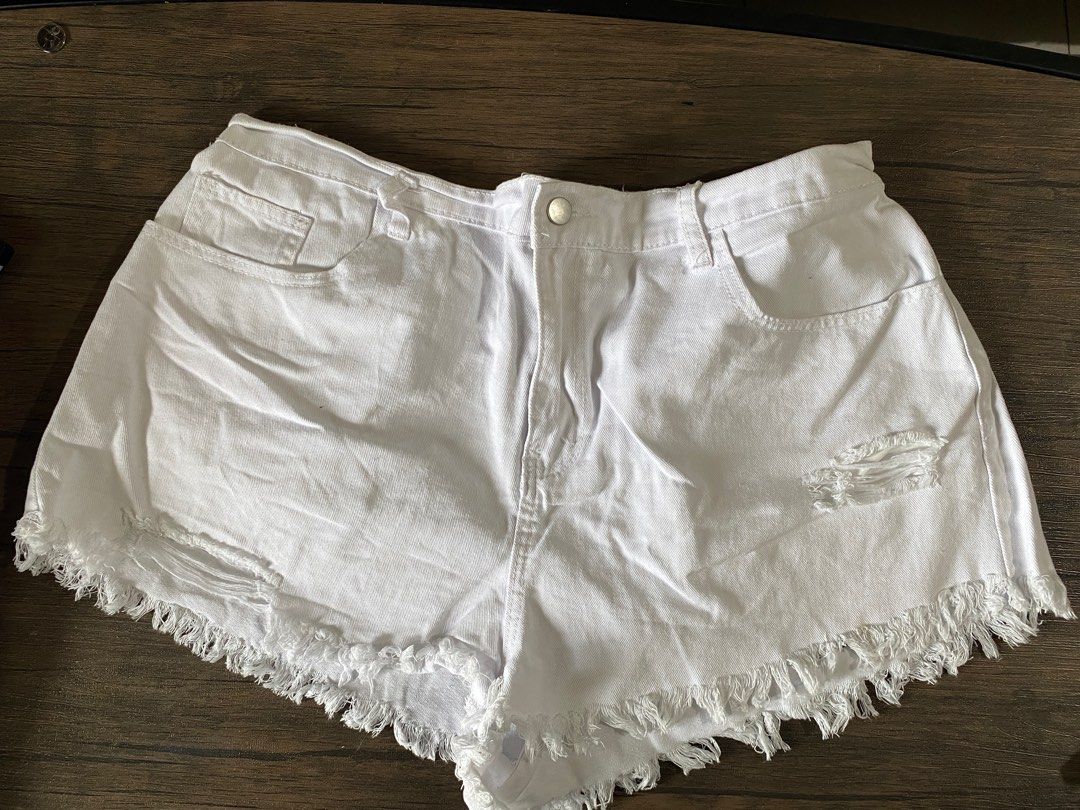 Distressed Denim Shorts with Frayed Hem (Category: Shorts) located in Quezon City. Submitted by jiujitsu_la (Listing ID 1464167039, Image 1). Description: - Cute denim shorts with a frayed hem. - Features distressing and rips for an edgy look. - Available in blue denim and white. - Ideal for casual wear. - Pairs well with t-shirts or crop tops. Php 250 each, take all 3 for Php 500.