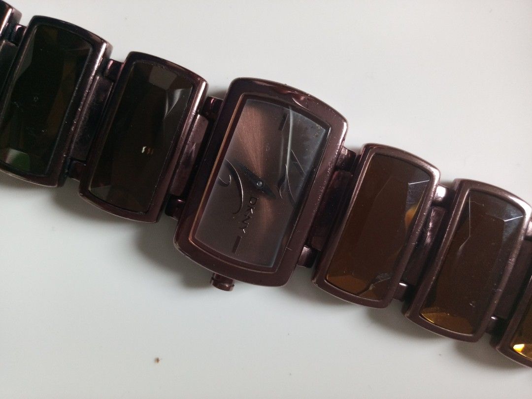 DKNY Rectangular Watch with Brown Stones (Category: Women's Watches) located in Malolos. Submitted by lizarondoe59660 (Listing ID 1464292373, Image 2). Description: - Brand: DKNY - Face Shape: Rectangular - Band Details: Rectangular brown stones - Case Material: Solid Stainless Steel Back - Good condition - No issue and No inclusions - Free shipping!.