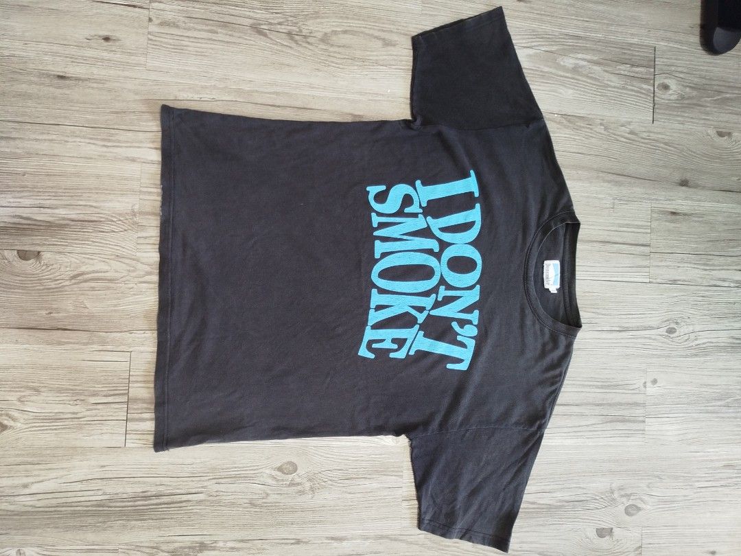Don smoke graphic tee (Category: Tshirts & Polo Shirts ) located in Quezon City. Submitted by y2k_thriftkid (Listing ID 1464206405, Image 1). Description: - Brand: Donsmoke - Color: Black with blue text - Text: 'I DON'T SMOKE' - Style: Casual wear - Condition: Good -DIMES 22x28 -ISSUE HAIRLINE.