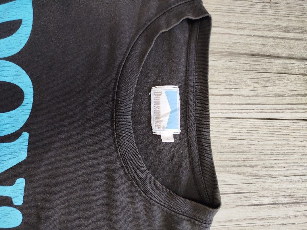 Don smoke graphic tee (Category: Tshirts & Polo Shirts ) located in Quezon City. Submitted by y2k_thriftkid (Listing ID 1464206405, Image 2). Description: - Brand: Donsmoke - Color: Black with blue text - Text: 'I DON'T SMOKE' - Style: Casual wear - Condition: Good -DIMES 22x28 -ISSUE HAIRLINE.