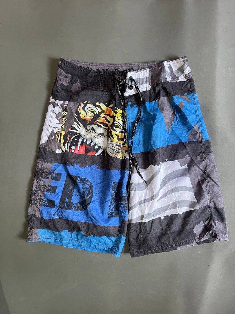 Ed Hardy Tiger & Logo Board Shorts (Category: Swim Trunks & Board Shorts) located in Panabo. Submitted by t-thrifts (Listing ID 1464186025, Image 1). Description: - Cool Ed Hardy board shorts - Features a bold tiger graphic and lettering - Elastic waistband with adjustable drawstring for a comfortable fit - Includes back pockets - Ideal for swimming, beach days, or casual lounging - Unique and eye-catching design.