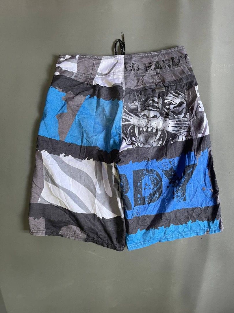 Ed Hardy Tiger & Logo Board Shorts (Category: Swim Trunks & Board Shorts) located in Panabo. Submitted by t-thrifts (Listing ID 1464186025, Image 2). Description: - Cool Ed Hardy board shorts - Features a bold tiger graphic and lettering - Elastic waistband with adjustable drawstring for a comfortable fit - Includes back pockets - Ideal for swimming, beach days, or casual lounging - Unique and eye-catching design.