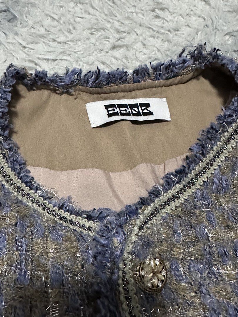 EENK Tweed Jacket with Embellished Buttons (Category: Coats, Jackets and Outerwear) located in Batangas. Submitted by kulilayfinds (Listing ID 1464221735, Image 2). Description: - EENK tweed jacket - Blue and brown checkered pattern - Embellished buttons on front and pockets - Frayed trim details - Estimated size: Medium - Perfect for dressing up or down - Lightweight tweed 😊 Best fits S to M EENK is a Korean brand..