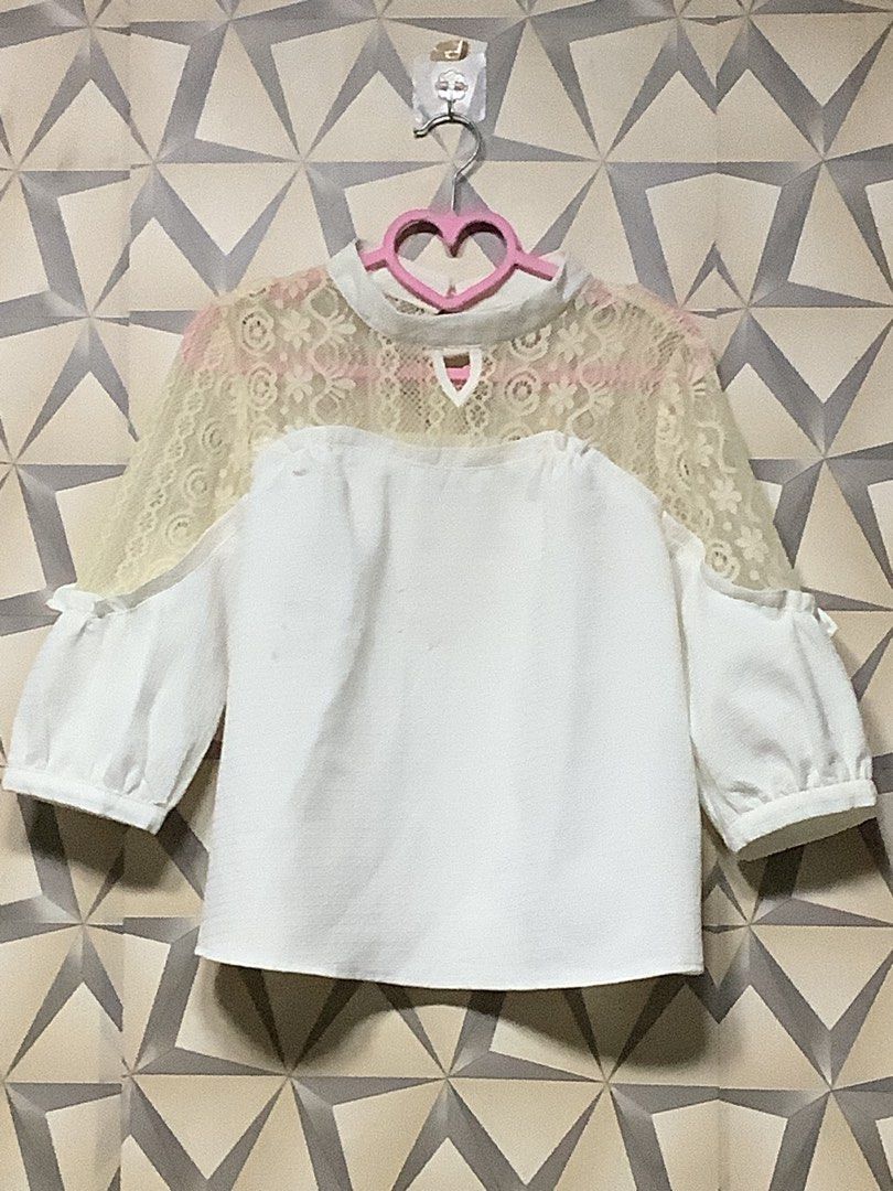 Elegant Lace-Panel Puff-Sleeve Blouse (Category: Blouses) located in Quezon City. Submitted by lovedbyerara (Listing ID 1464272314, Image 1). Description: Design Layout: It features a solid white opaque body panel juxtaposed with a sheer, floral-patterned lace yoke spanning across the upper chest, shoulders, and back. Neckline Detail: Designed with a mock-neck style collar, accented by a subtle teardrop keyhole cut-out at the center front. Sleeve