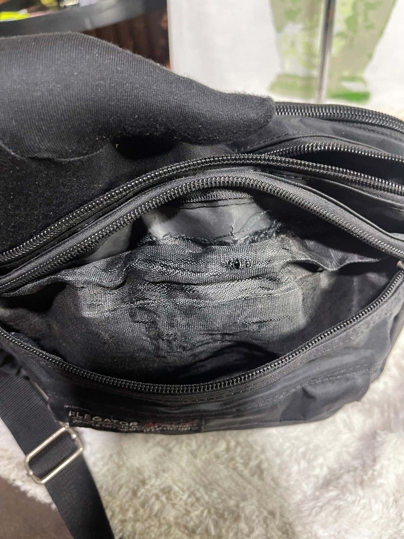 Elegator Quality Black Nylon Crossbody Bag (Category: Cross-body Bags) located in Naawan. Submitted by twilly.apparel2 (Listing ID 1464240220, Image 3). Description: - issue sa labas and sa loob Durable black nylon crossbody bag - Multiple zippered compartments for easy organization - Adjustable strap for comfortable carrying - Convenient front pocket with flap closure - Ideal for everyday use or travel - Please note: Minor scuffs on the front po