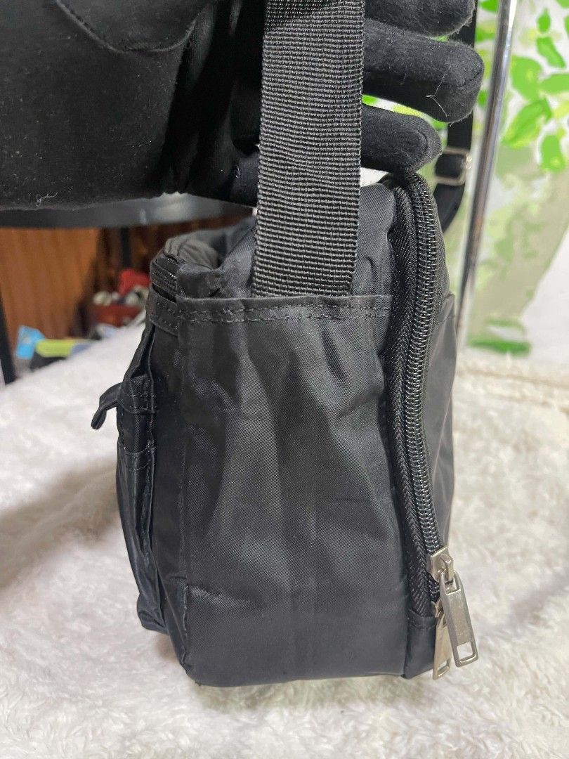 Elegator Quality Black Nylon Crossbody Bag (Category: Cross-body Bags) located in Naawan. Submitted by twilly.apparel2 (Listing ID 1464240220, Image 2). Description: - issue sa labas and sa loob Durable black nylon crossbody bag - Multiple zippered compartments for easy organization - Adjustable strap for comfortable carrying - Convenient front pocket with flap closure - Ideal for everyday use or travel - Please note: Minor scuffs on the front po