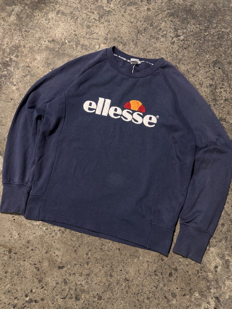 Ellesse Navy Blue Sweatshirt (Category: Coats, Jackets and Outerwear) located in Pasig City. Submitted by dripthrift1600 (Listing ID 1464246926, Image 1). Description: - Navy blue Ellesse sweatshirt - Classic Ellesse logo on front - Raglan sleeves - Ribbed cuffs and hem - Made in Italy - Size M - Ideal for casual wear - Dimes: 24x27.