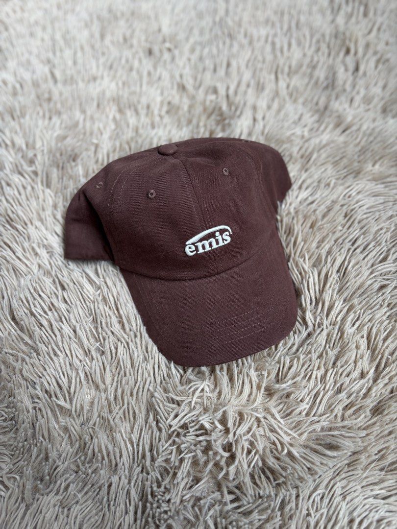 Emis Brown Baseball Cap (Category: Caps & Hats) located in Quezon City. Submitted by nojthrift (Listing ID 1464252192, Image 1). Description: - Brand: Emis - Color: Brown - Style: Baseball Cap - Features: Embroidered Emis logo on front - Material: 100% Cotton - Fit: Adjustable strap at the back - Ideal for: Everyday wear.