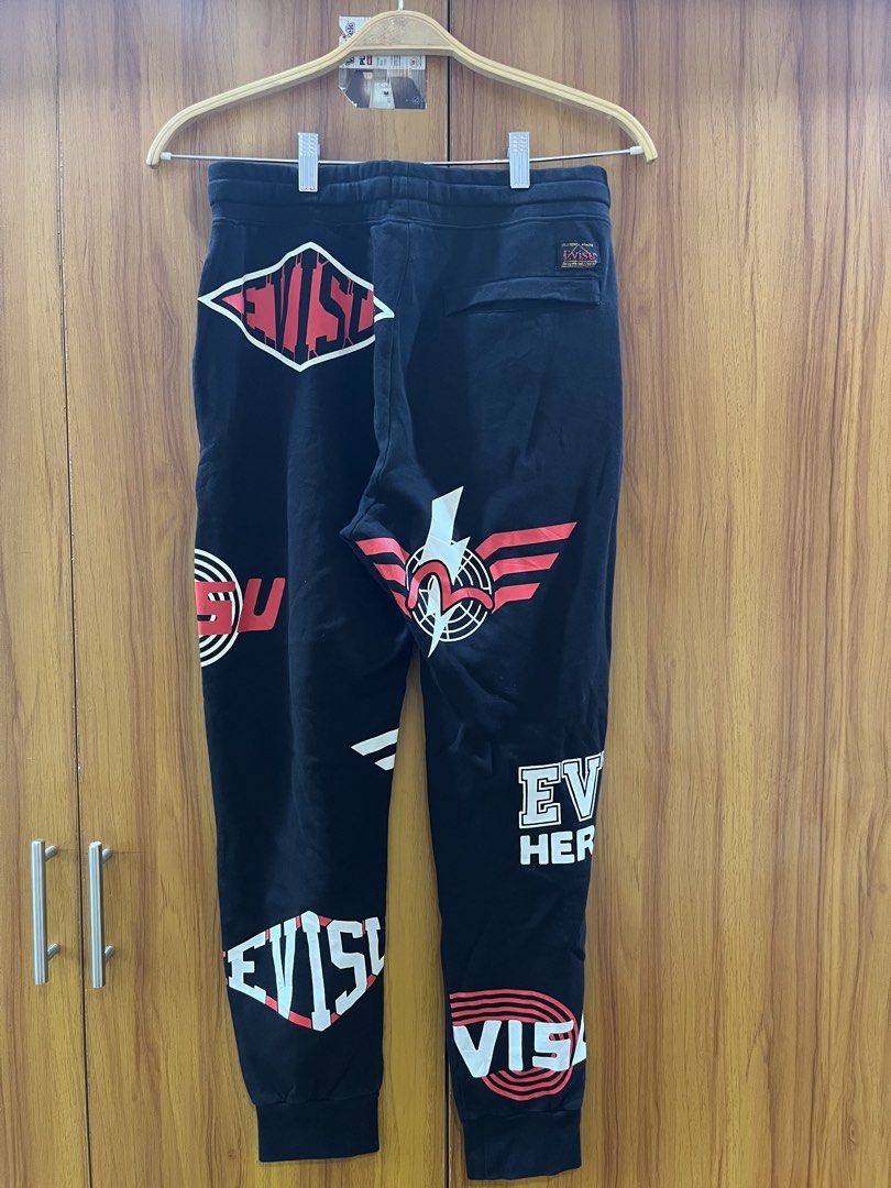 EVISU Black Sweatpants with Graphic Print (Category: Joggers) located in Manila. Submitted by christian048 (Listing ID 1464229219, Image 3). Description: - Brand: Evisu - Color: Black - Size: S - Features: Multiple graphic prints (front & back), elastic waistband with drawstring, ribbed cuffs - Style: Casual wear - Authentic .