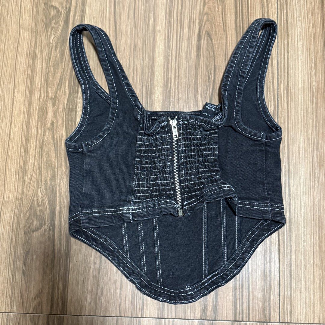 Factory Black Denim Corset Top with Zipper (Category: Sleeveless) located in Binangonan. Submitted by curatedbyjuys (Listing ID 1464351222, Image 2). Description: - Black denim corset top - Front zipper closure - White contrast stitching throughout - Strappy design - Estimated size: S or M - Ideal for going out or dressing up an outfit.