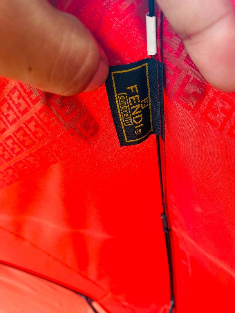 Fendi Red Monogram Umbrella (Category: Umbrellas) located in Caloocan City. Submitted by joshuadyogi0122 (Listing ID 1464165252, Image 3). Description: - Authentic Red Fendi Umbrella - Iconic FF Monogram pattern along the edge - Features a metal Fendi logo detail on the handle - Compact and easy to carry - Perfect for rainy days - Shows some signs of use but remains fully functional.
