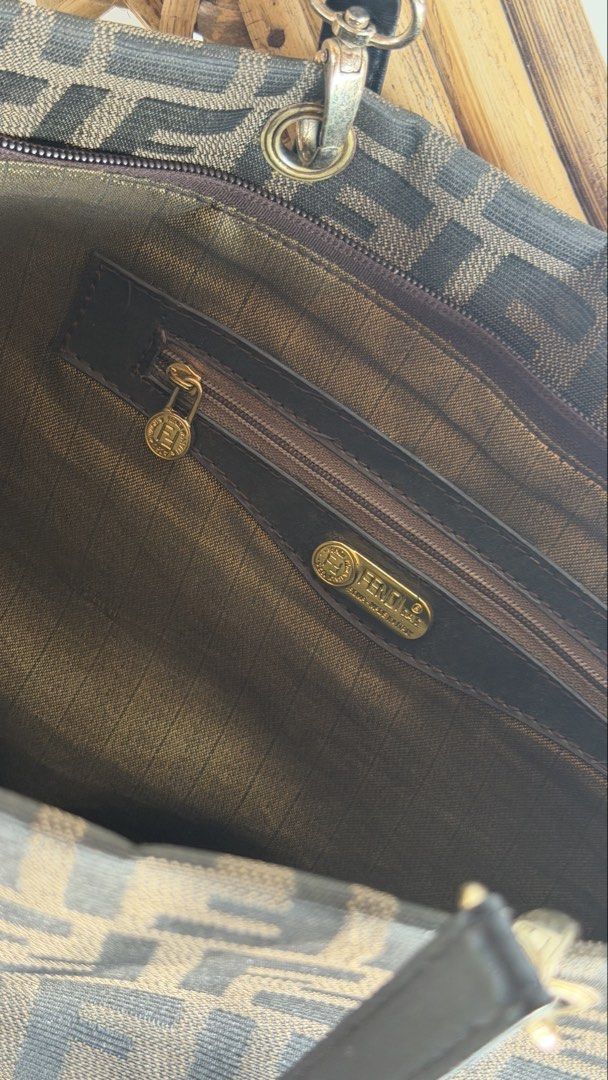 Fendi Zucca Canvas Tote Bag (Category: Tote Bags) located in Batangas. Submitted by prelove.kk (Listing ID 1464219963, Image 2). Description: - Classic Fendi Zucca pattern tote bag - Color: Brown and black canvas - Trim: Genuine leather - Interior: Zip pocket with Fendi logo zipper pull - Hardware: Gold tone - Ideal for everyday essentials.