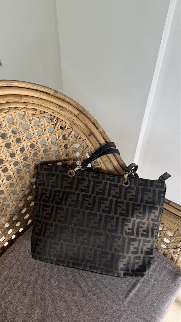 Fendi Zucca Canvas Tote Bag (Category: Tote Bags) located in Batangas. Submitted by prelove.kk (Listing ID 1464219963, Image 1). Description: - Classic Fendi Zucca pattern tote bag - Color: Brown and black canvas - Trim: Genuine leather - Interior: Zip pocket with Fendi logo zipper pull - Hardware: Gold tone - Ideal for everyday essentials.