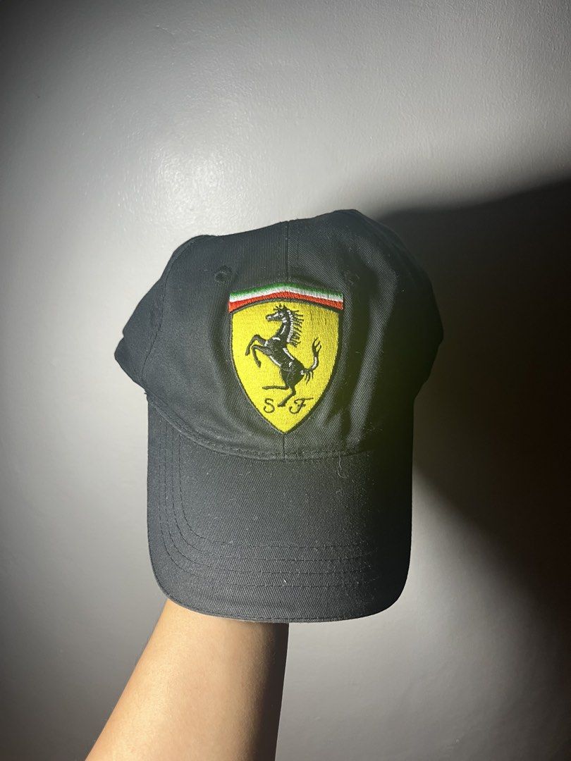 Ferrari Scuderia Formula 1 Racing Cap Hat (Category: Caps & Hats) located in Cavite. Submitted by majaco (Listing ID 1464314375, Image 2). Description: - Iconic black Ferrari cap - Features the Scuderia shield logo embroidered on the front - Adjustable strap at the back for a custom, comfortable fit - One size fits most - Ideal for Formula 1 enthusiasts and Ferrari supporters.