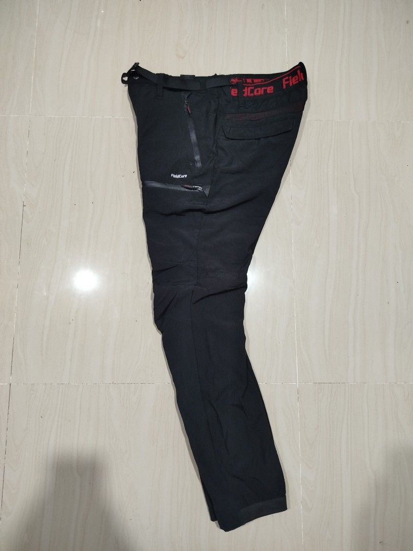 FieldCore Diamagic waterproof pants (Category: Trousers) located in Aroroy. Submitted by dr0p-a-dr1p (Listing ID 1464206458, Image 2). Description: Waist: 30-32 Length: 40 - Waterproof - Brand: FieldCore - Color: Black - Pockets: Multiple zippered pockets on front and sides - Closure: Integrated belt with buckle - Waistband: Red elastic band with FieldCore logo - Ideal for: Hiking, outdoor activities - Condition: Please check photos for details.
