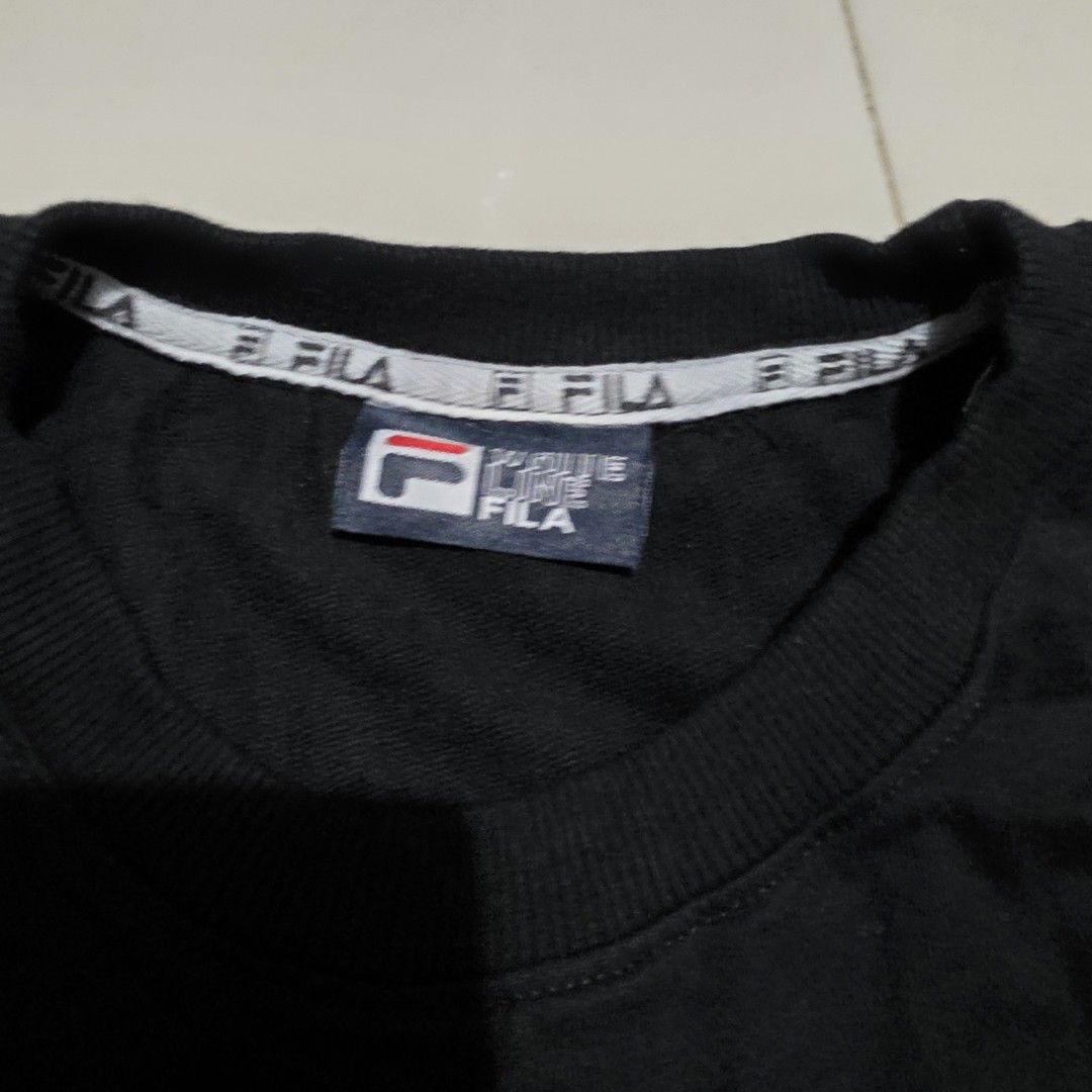 Fila White Line Black Sweatshirt (Category: Coats, Jackets and Outerwear) located in Quezon City. Submitted by kick_mnl (Listing ID 1464165357, Image 2). Description: - Classic black Fila sweatshirt - Features iconic Fila logo with white and red accents - Fila branded tape on the collar - Perfect for casual everyday wear - Approximately 24 inches in width.
