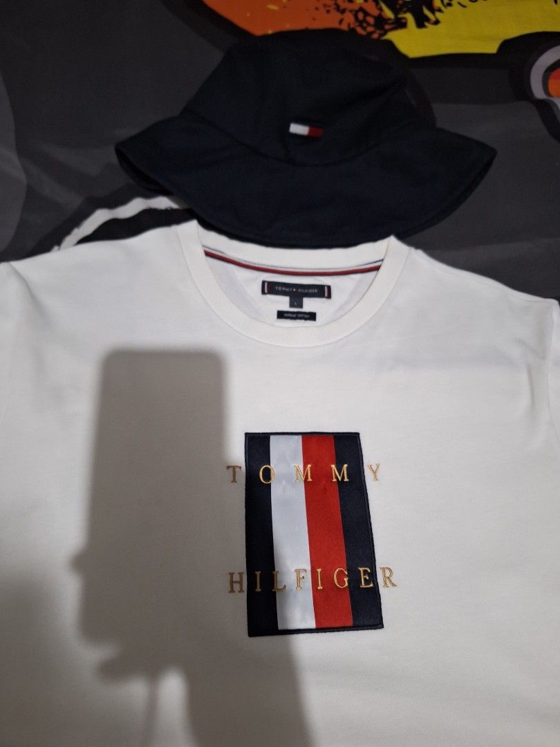 Forsale aspack nego pa (Category: Caps & Hats) located in Manila. Submitted by adolphreyes645 (Listing ID 1464303400, Image 1). Description: - White Tommy Hilfiger T-shirt - Size: L - Material: Organic Cotton - Features classic Tommy flag logo on chest - Navy Tommy Jeans Bucket Hat - Size: OS (One Size) - Ideal for casual wear - Both items feature Tommy branding.