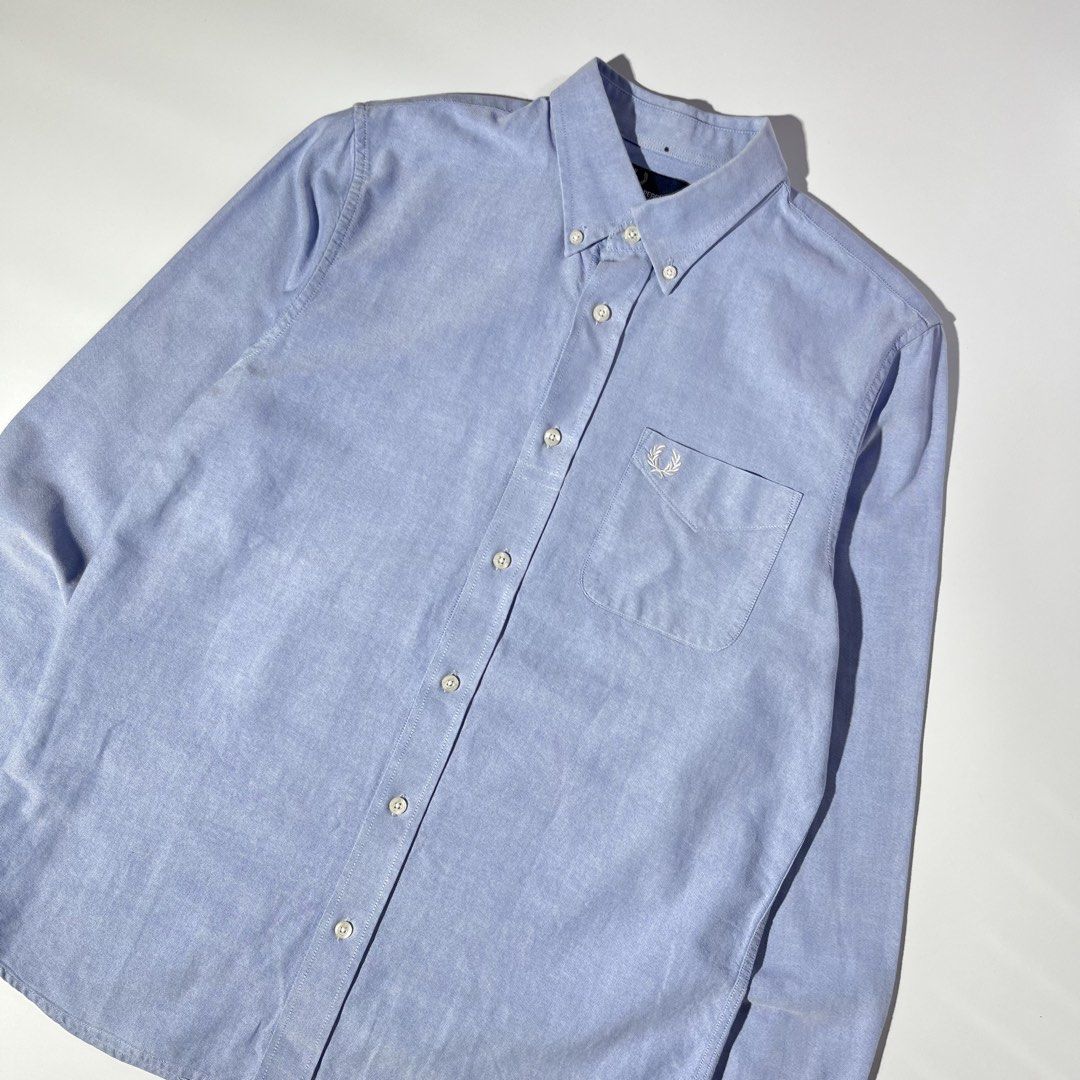 Fred Perry Oxford Shirt Blue Size M (Category: Formal Shirts) located in Panabo. Submitted by bae.sick_thirft (Listing ID 1464143002, Image 2). Description: Classic blue Oxford shirt from Fred Perry • Condition - Excellent • Color rate - 9.7/10 • Ribbings and hem masikip • Issue(s) - minimal marker (not visible) • Perfect for dates Dimes: • Width - 21 • Lenght - 29 • Size - Medium to Large Price - DM .
