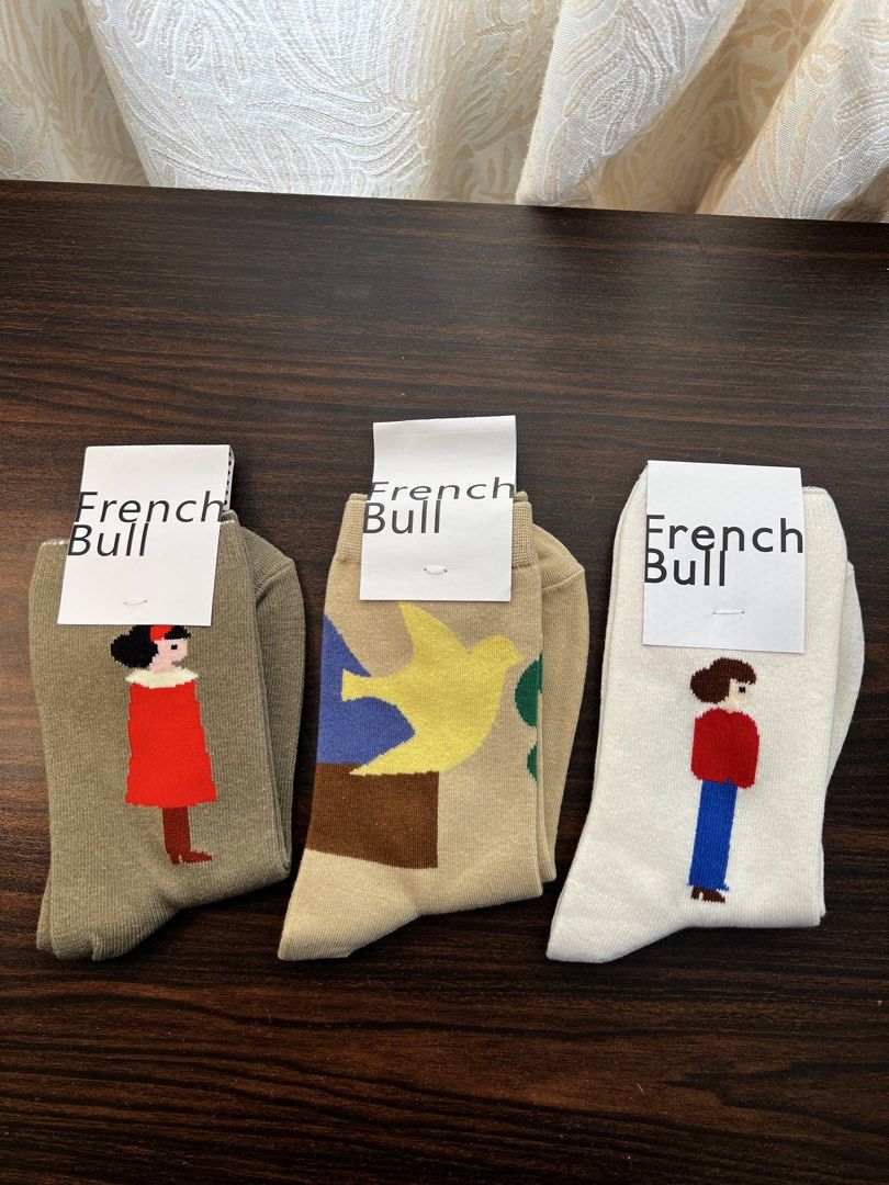 French Bull Socks - Cute Character Designs (Category: Socks & Tights) located in Makati City. Submitted by ciriacoria (Listing ID 1464184343, Image 3). Description: - Set of 5 French Bull socks - Features fun character designs: person in blue coat, fluffy dog, person in striped shirt, person in red dress, and a bird - Adds personality to any outfit - Soft and comfortable material.