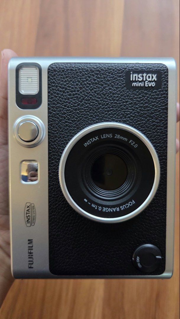 Fujifilm Instax Mini Evo (Category: Cameras) located in Quezon City. Submitted by mh0301 (Listing ID 1464189349, Image 3). Description: - Fujifilm Instax Mini 99 camera - Stylish silver and black finish - Easy-to-use print button - Convenient top dial for settings - Includes hot shoe mount - Ideal for capturing instant memories.