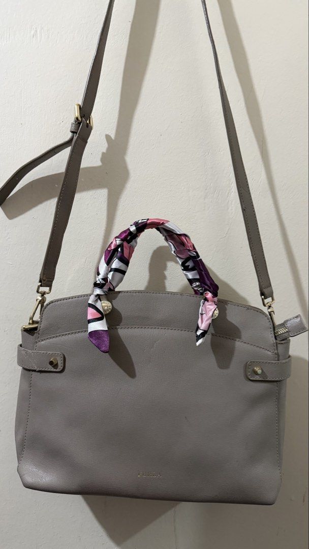 Furla Agata Medium Gray Leather Bag (Category: Luxury Bags & Wallets) located in Rizal. Submitted by lovegclothingph (Listing ID 1464286520, Image 1). Description: - Furla gray leather crossbody bag - Comes with twilly due to damaged handles - Includes a detachable crossbody strap for versatile wear - Features elegant gold hardware details - Secure side zipper closure - With marks present on the bag and base - RFS: Decluttering.