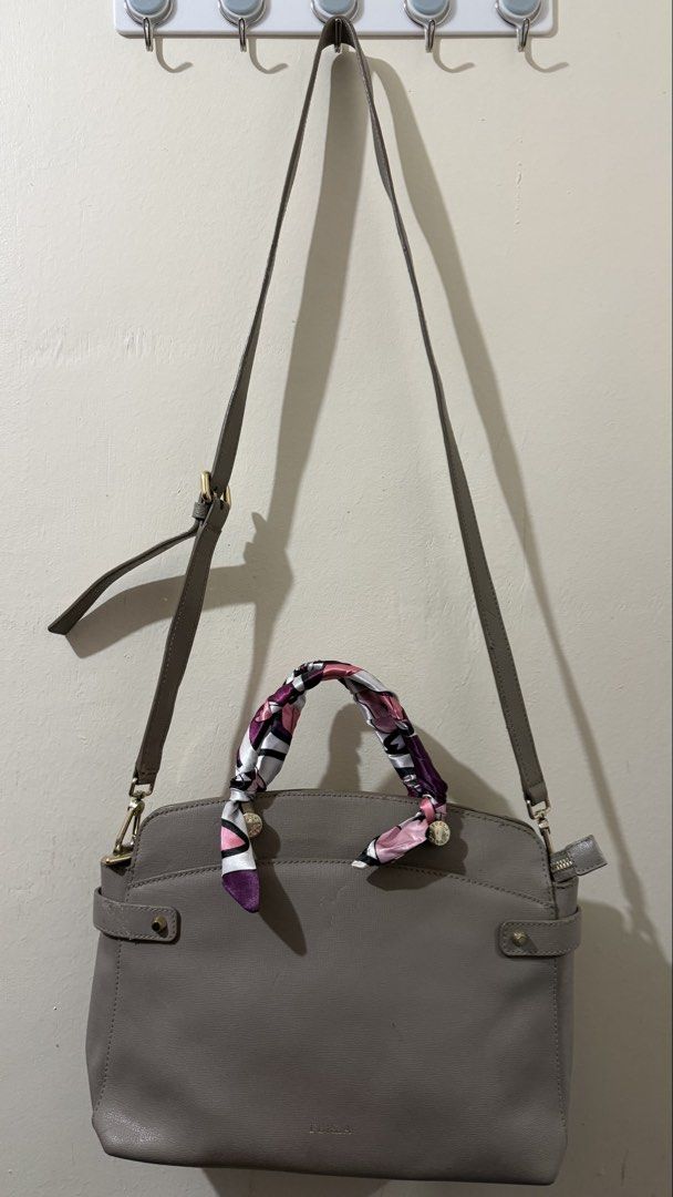 Furla Agata Medium Gray Leather Bag (Category: Luxury Bags & Wallets) located in Rizal. Submitted by lovegclothingph (Listing ID 1464286520, Image 2). Description: - Furla gray leather crossbody bag - Comes with twilly due to damaged handles - Includes a detachable crossbody strap for versatile wear - Features elegant gold hardware details - Secure side zipper closure - With marks present on the bag and base - RFS: Decluttering.