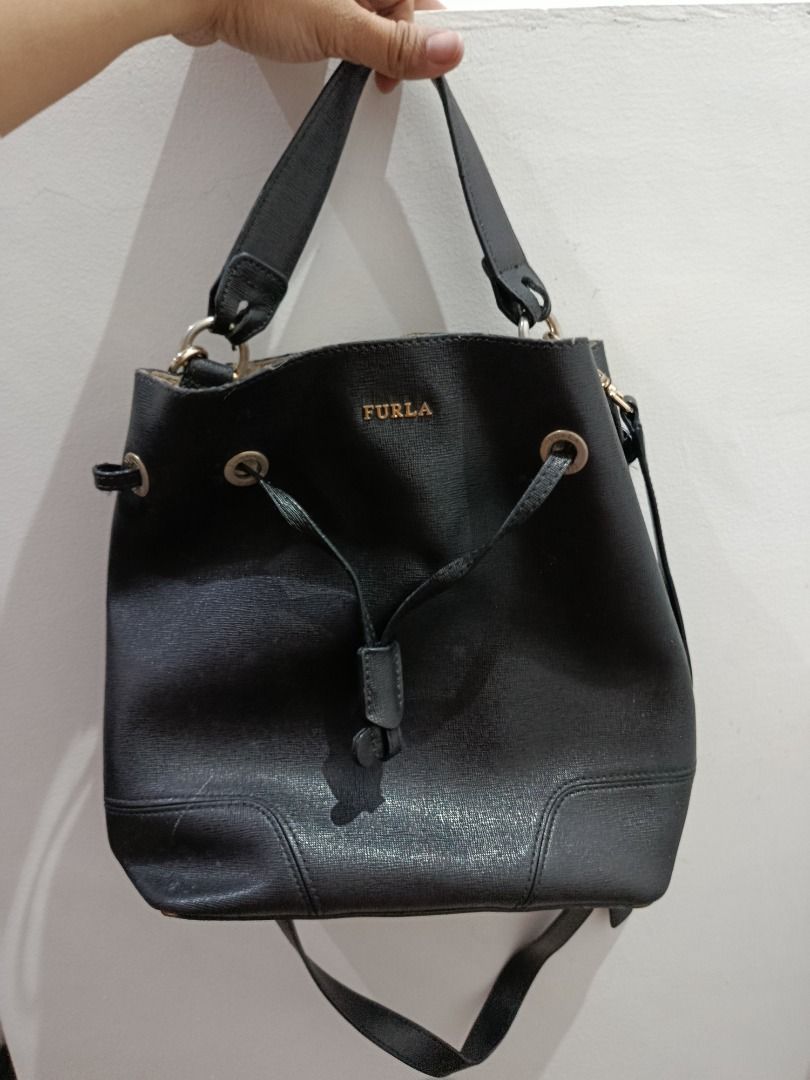 Furla Black Leather Bucket Bag (Category: Luxury Bags & Wallets) located in Pasay City. Submitted by coolfire.dc0ea2 (Listing ID 1464183266, Image 1). Description: - Authentic Furla bucket bag in classic black. - Crafted from genuine leather for a premium feel. - Secure drawstring closure to keep your belongings safe. - Versatile carrying options: top handles and a detachable shoulder strap. - Elegant gold-tone hardware. - Please note: slight wea