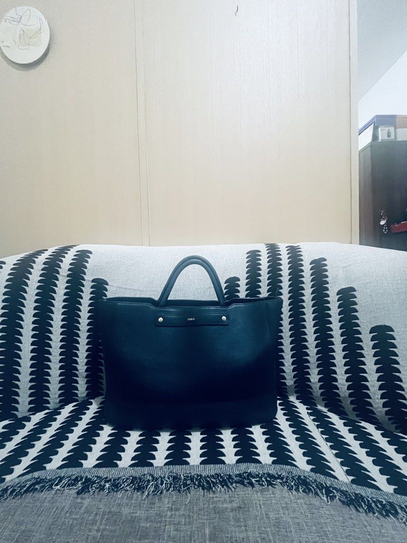 Furla Tote Bag Navy Blue Leather (Category: Tote Bags) located in Quezon City. Submitted by dressuposhoppe (Listing ID 1464208735, Image 2). Description: - Navy blue Furla tote bag - Genuine leather - Spacious interior, ideal for daily essentials - Comfortable top handles - Secure zipper closure - Classic, minimalist design.