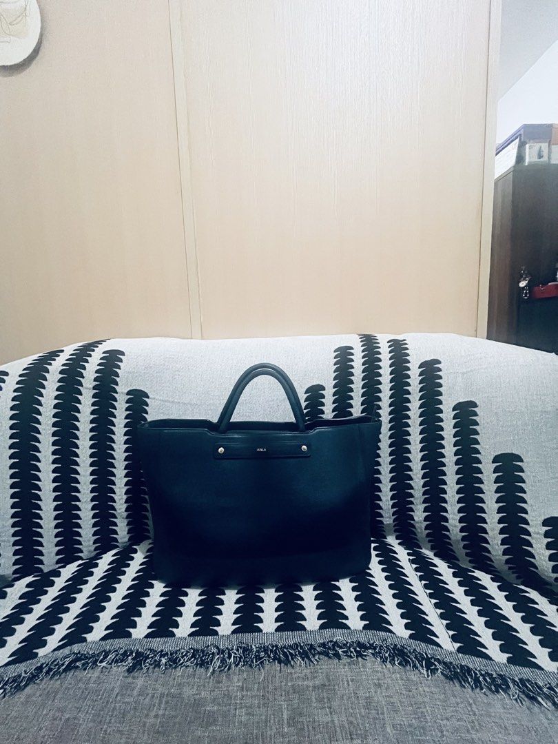 Furla Tote Bag Navy Blue Leather (Category: Tote Bags) located in Quezon City. Submitted by dressuposhoppe (Listing ID 1464208735, Image 3). Description: - Navy blue Furla tote bag - Genuine leather - Spacious interior, ideal for daily essentials - Comfortable top handles - Secure zipper closure - Classic, minimalist design.