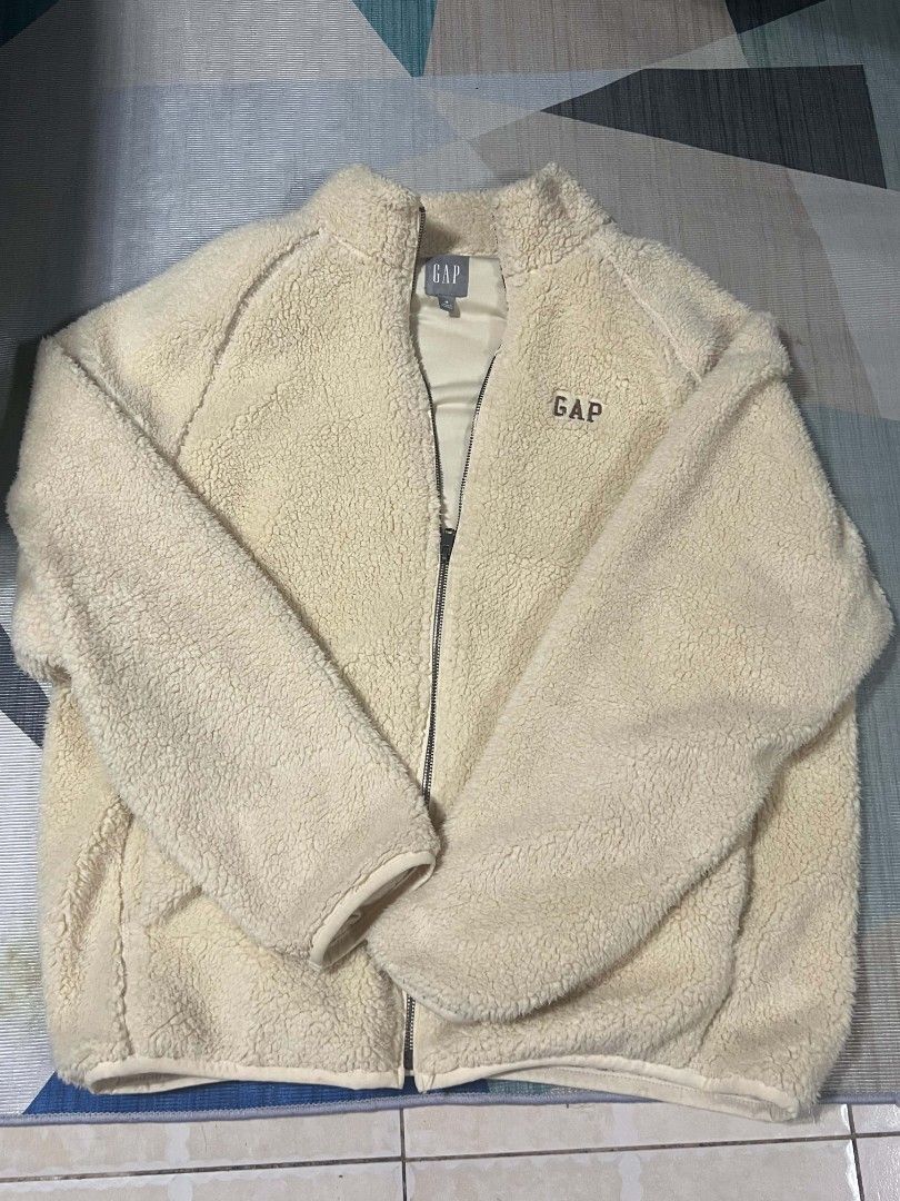 GAP Fleece Zip-Up Jacket Cream (Category: Coats, Jackets and Outerwear) located in Mandaluyong City. Submitted by kel_dypy (Listing ID 1464299662, Image 2). Description: - Cream colored fleece jacket from GAP - Full zip closure with stand-up collar - Soft and cozy material, ideal for cooler weather - Classic, easy-to-style design - Perfect for casual outings and layering with jeans or leggings GAP LOGO SHERPA FLEECE FULL ZIP JACKET bought this ar
