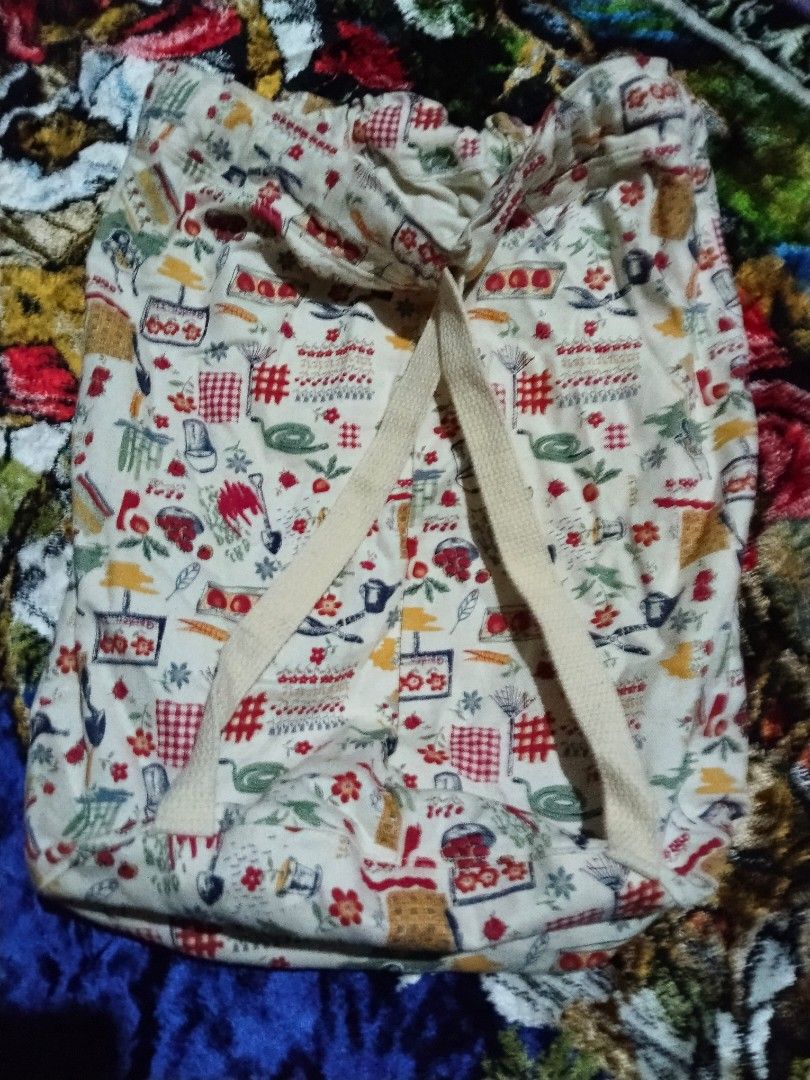 Garden Print Drawstring Backpack (Category: Backpacks) located in Mabalacat. Submitted by al_amin_thrift (Listing ID 1464225734, Image 2). Description: 🌿 Vintage Garden Print Drawstring Backpack Item Details - Style: Drawstring / cinch backpack ​ - Material: Soft, durable cotton canvas — lightweight yet sturdy ​ - Base Color: Cream / off-white ​ - Pattern: Whimsical all-over print featuring gardening & kitchen motifs — trowels, rakes, watering c